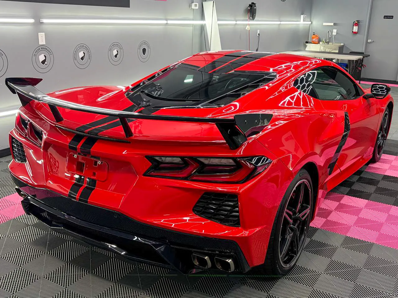 Rear three-quarter view of Stella showing the spoiler and quad exhaust